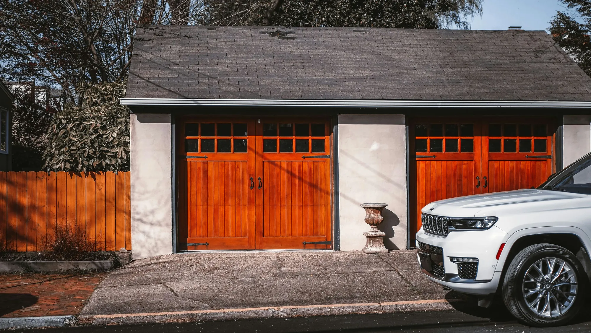 Wood carriage-style garage doors with small windows along the top