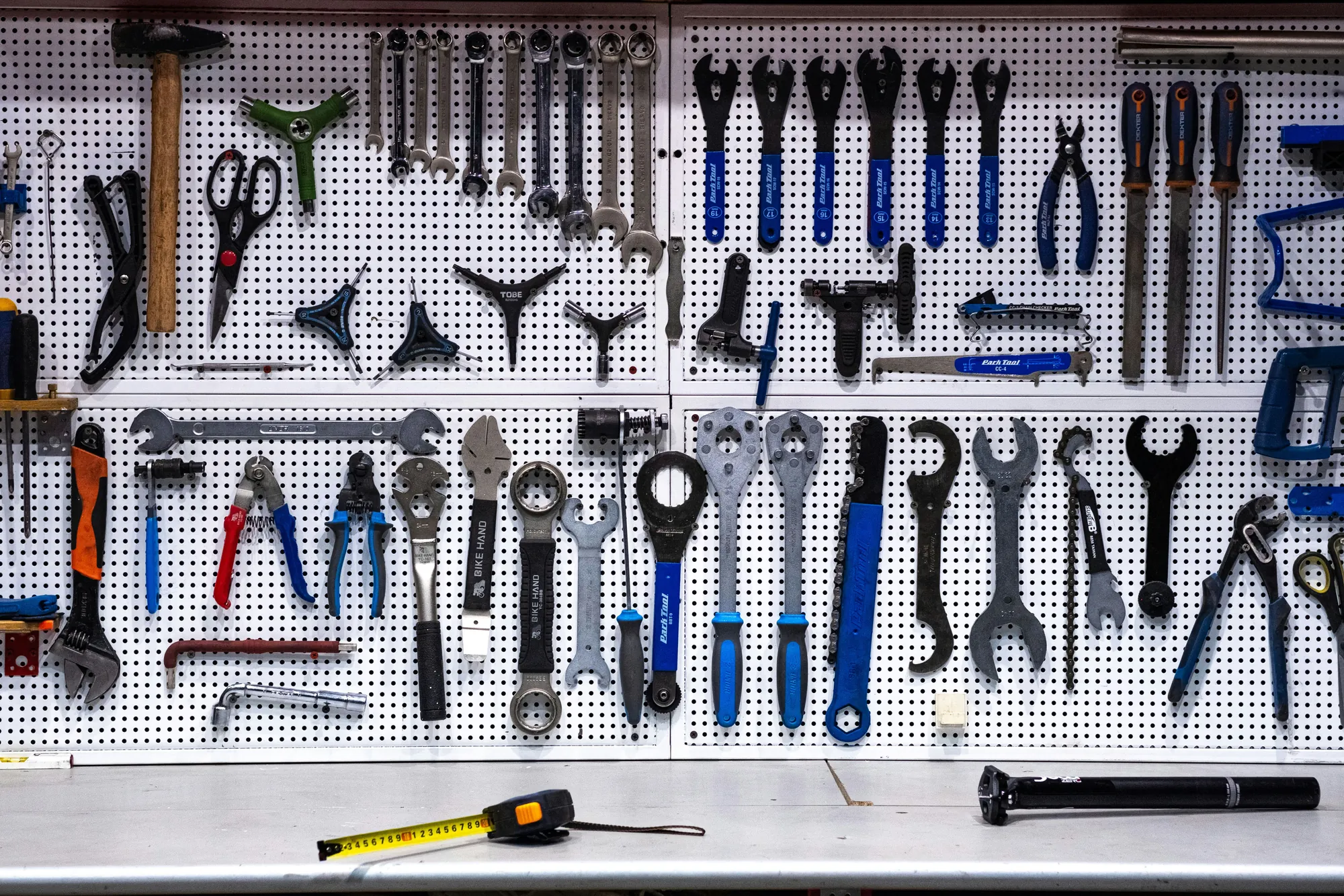 A tidy pegboard wall of hand tools, each one hanging in its place